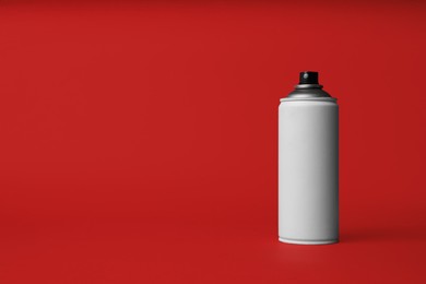 Photo of Can of spray paint on red background, space for text. Graffiti supply