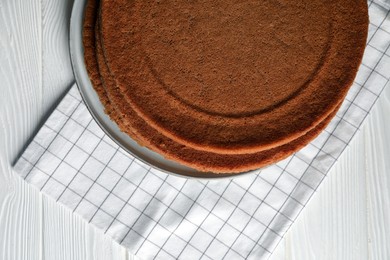Photo of Delicious homemade sponge cakes on white wooden table, top view