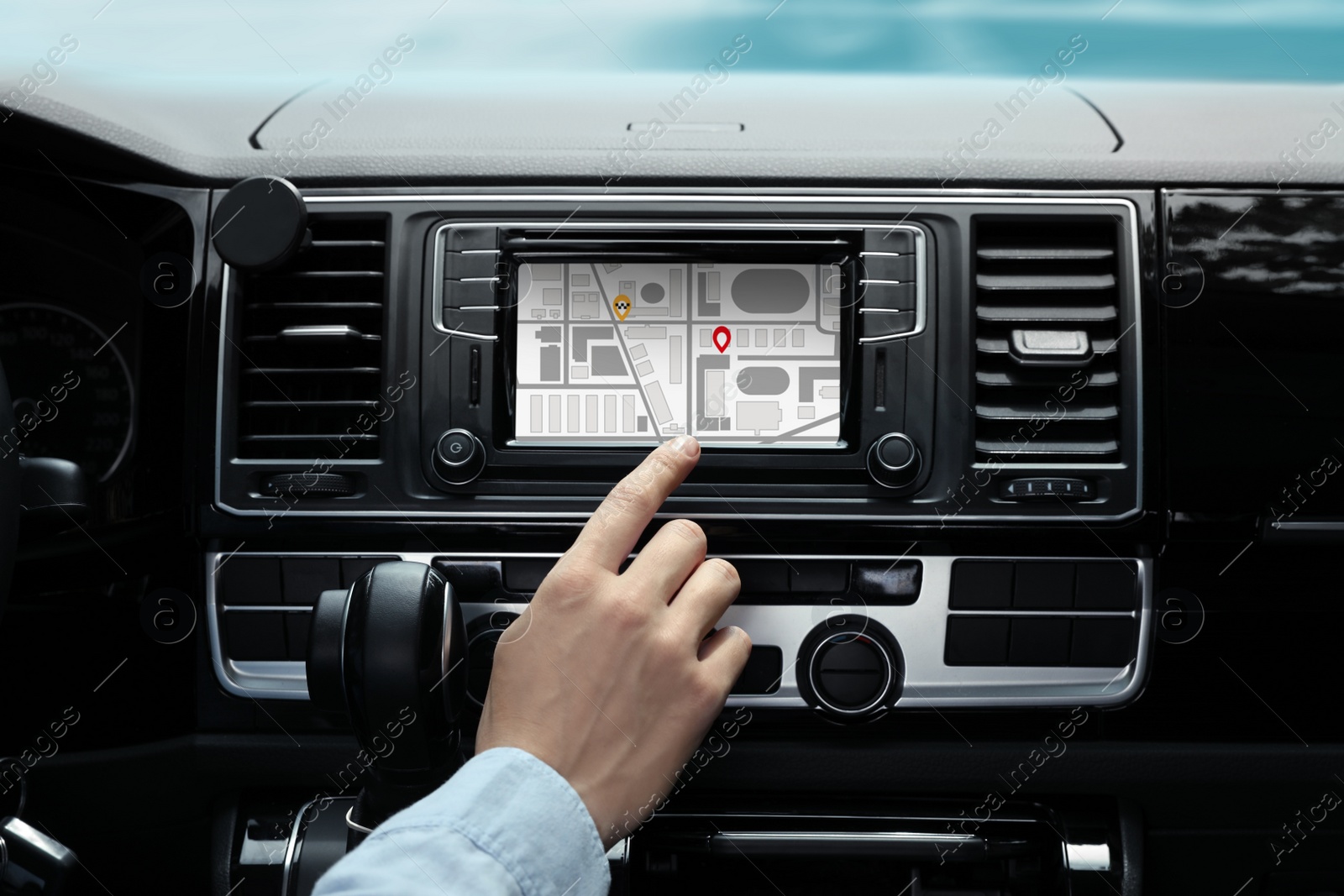 Image of Man using navigation system while driving car, closeup