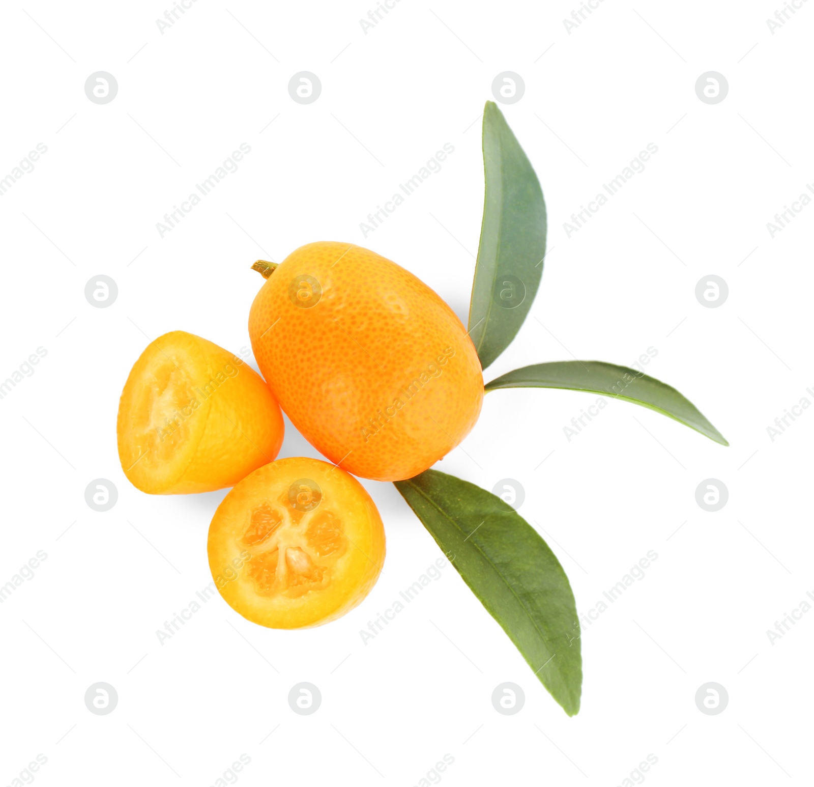 Photo of Whole and cut ripe kumquats with leaves on white background, top view. Exotic fruit