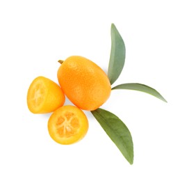 Photo of Whole and cut ripe kumquats with leaves on white background, top view. Exotic fruit