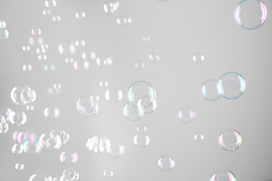 Photo of Beautiful transparent soap bubbles on grey background