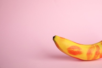Photo of Fresh banana with red lipstick marks on pink background, space for text. Oral sex concept