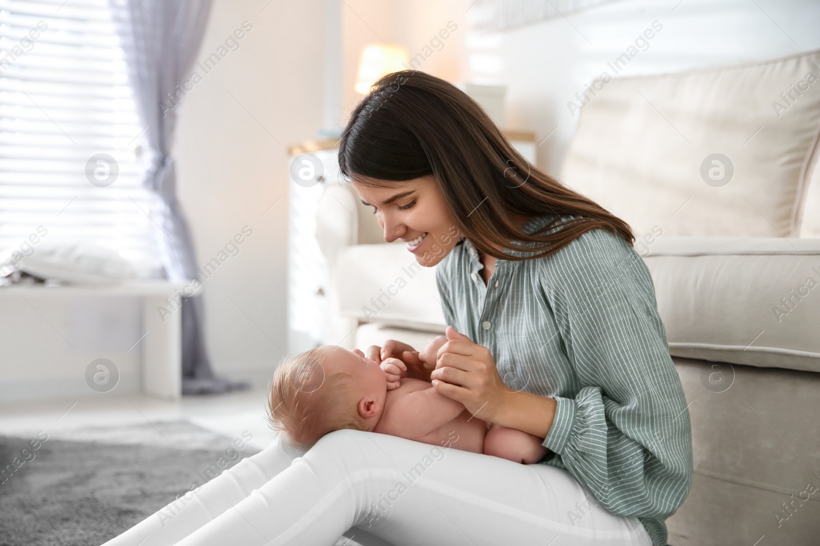 Photo of Mother with her newborn baby at home