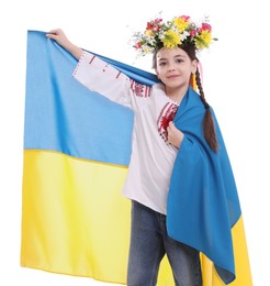 Photo of Little girl in national clothes with flag of Ukraine on white background
