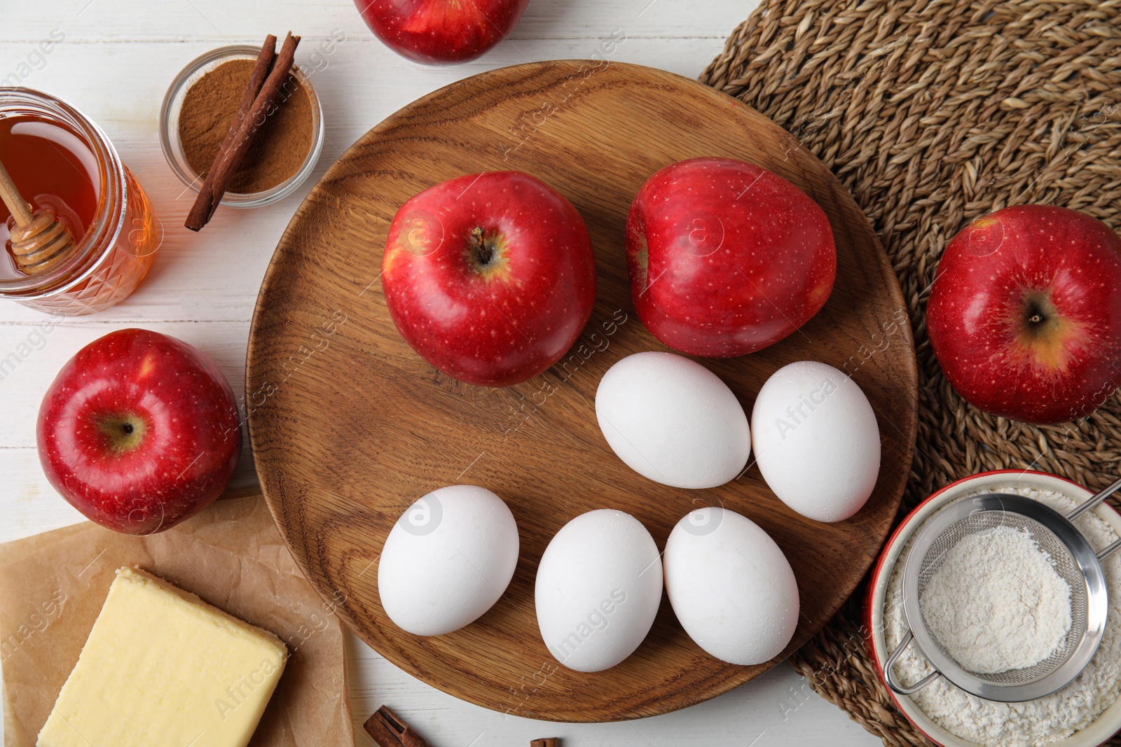 Photo of Traditional English apple pie ingredients on white wooden table, flat lay