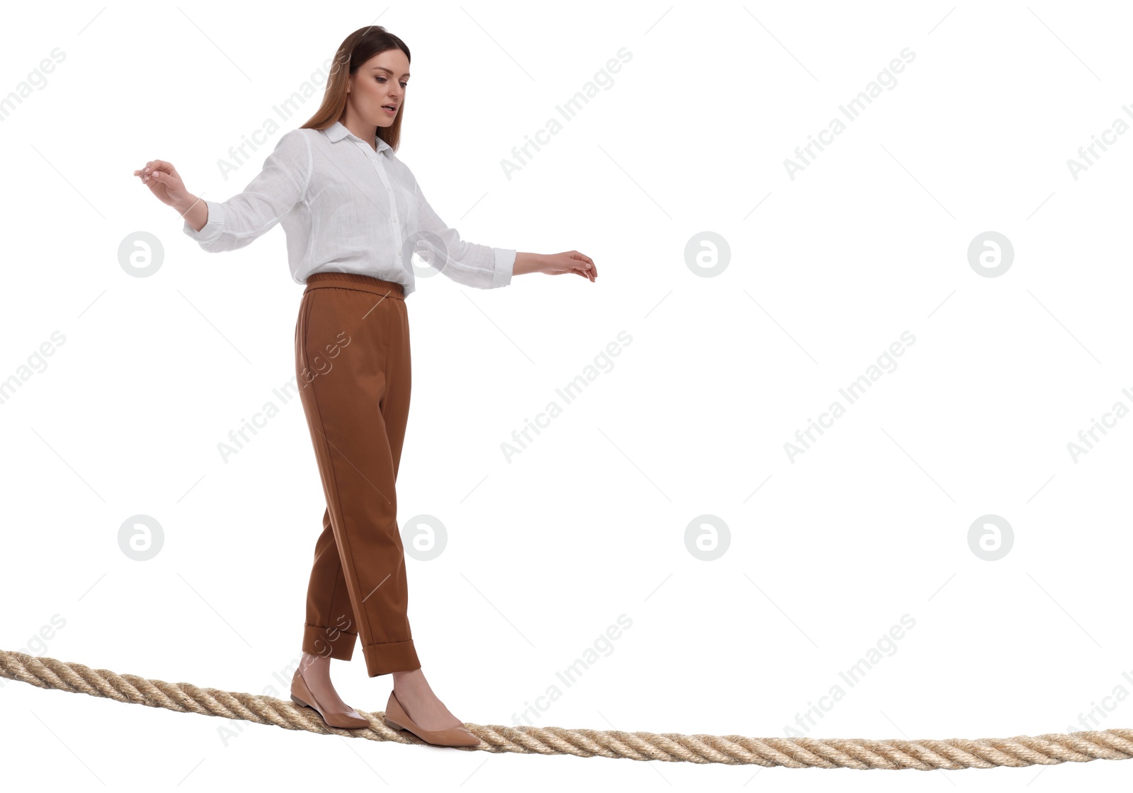 Image of Businesswoman walking rope against white background. Risk or balance concept