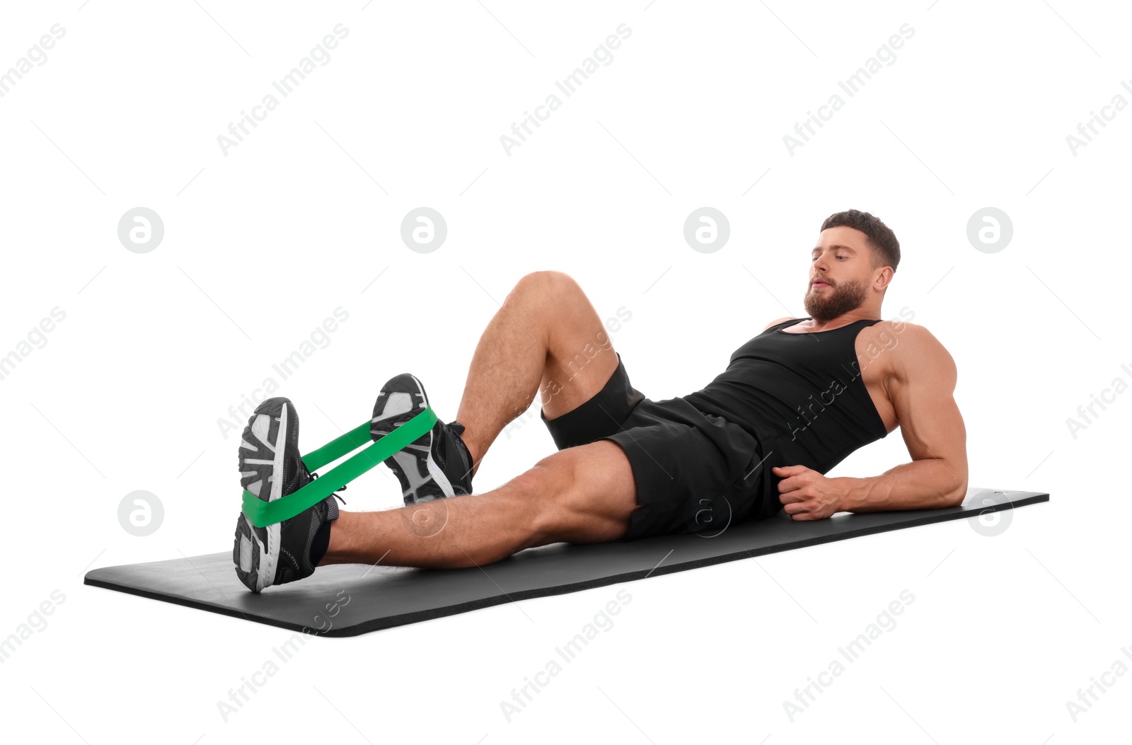 Photo of Young man exercising with elastic resistance band on fitness mat against white background