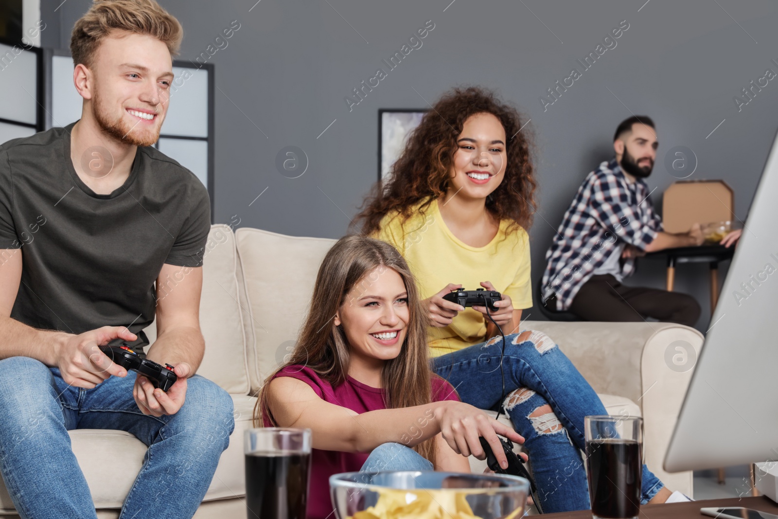 Photo of Emotional friends playing video games at home