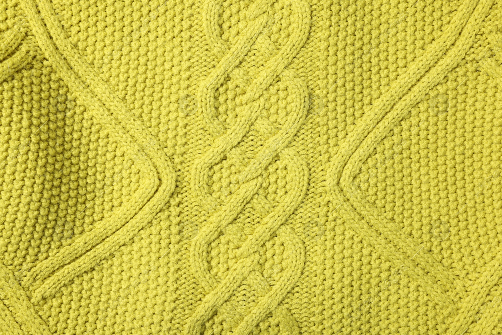 Photo of Texture of soft yellow fabric as background, top view