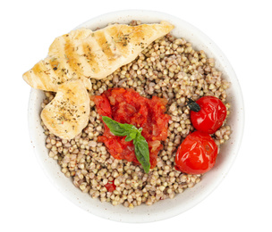 Photo of Tasty buckwheat porridge with meat and vegetables isolated on white, top view