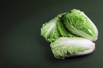 Fresh ripe Chinese cabbages on green background, above view. Space for text