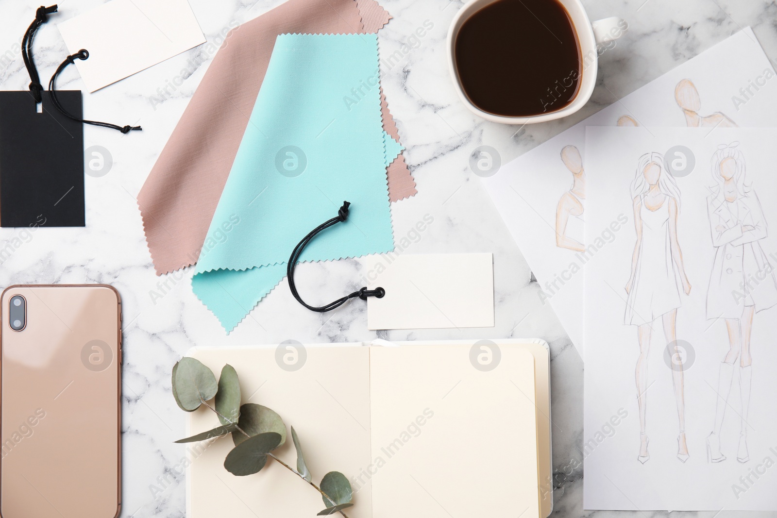 Photo of Flat lay composition with sketches and smartphone on white marble table. Designer's workplace