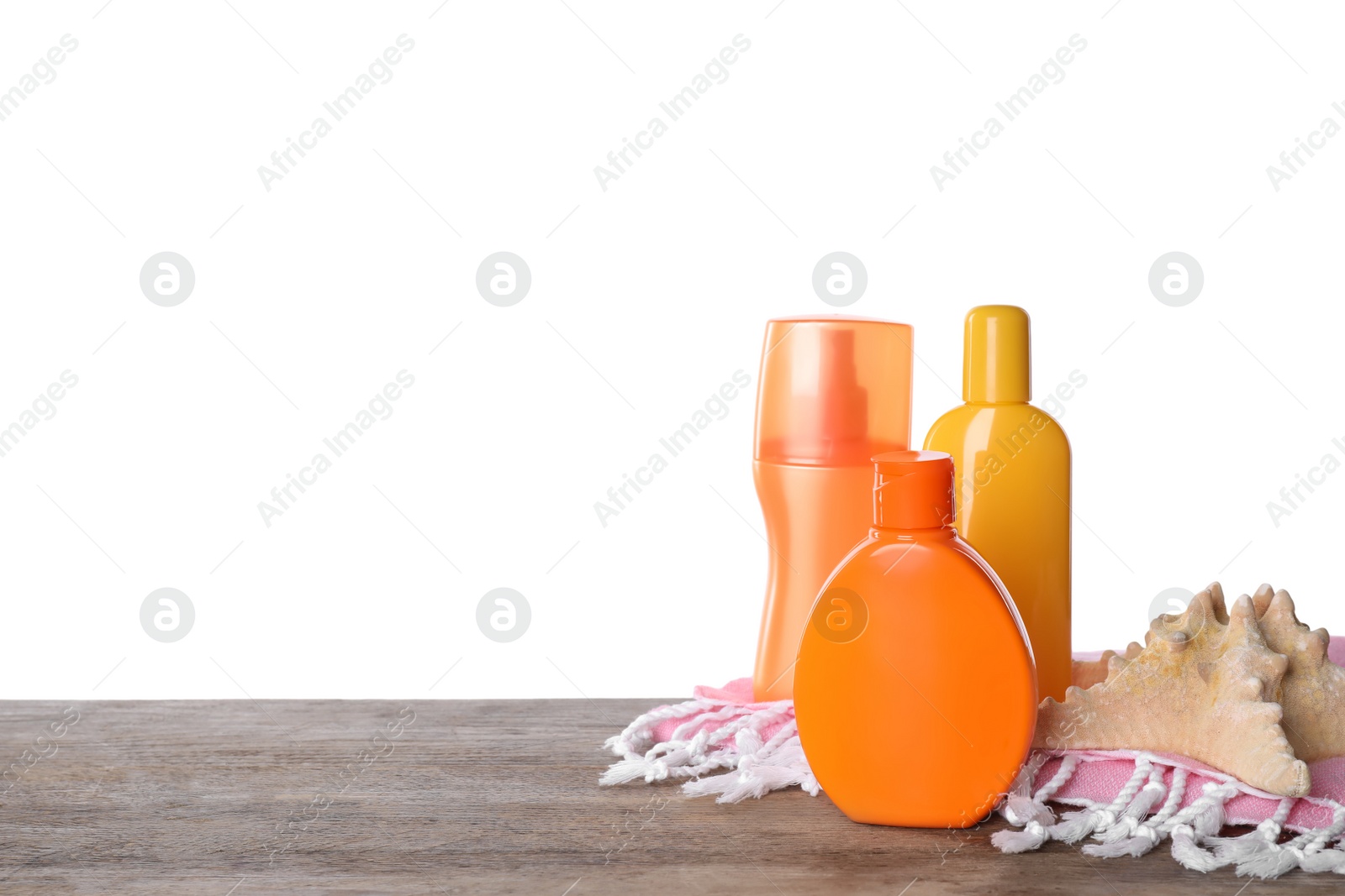 Photo of Sun protection products, beach towel and starfish on wooden table against white background. Space for text