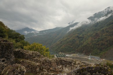 Photo of View on stone ruins and forest in mountains