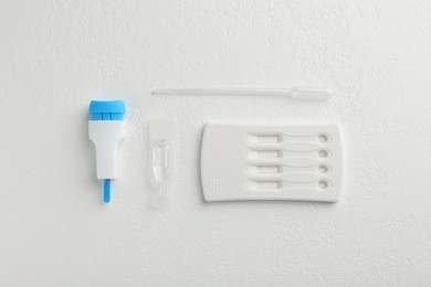 Photo of Disposable express test kit on white table, flat lay