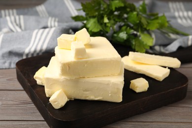 Pieces of tasty butter on wooden table