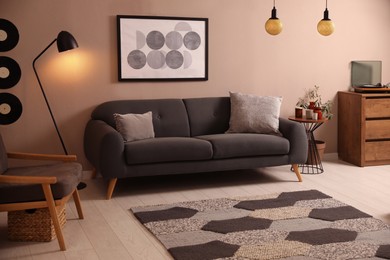 Stylish living room interior with comfortable dark sofa