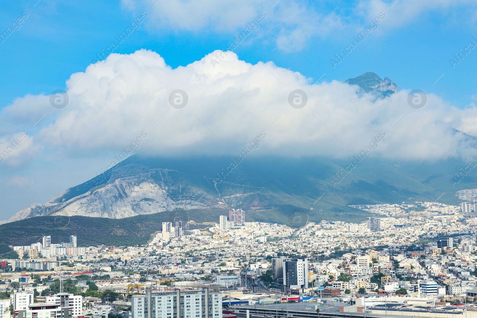 Photo of Picturesque view of cityscape with many buildings near mountain