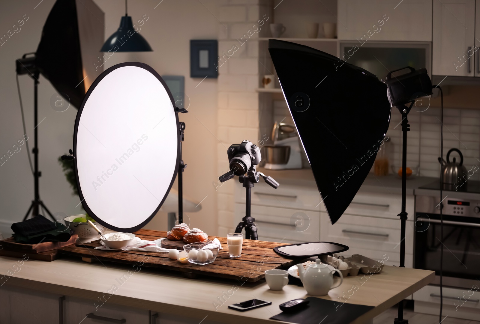 Photo of Professional photo equipment and food composition on table in studio