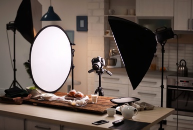 Professional photo equipment and food composition on table in studio