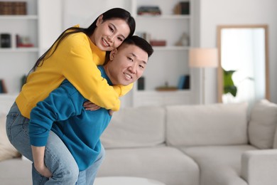 Photo of Happy couple spending time together at home, space for text