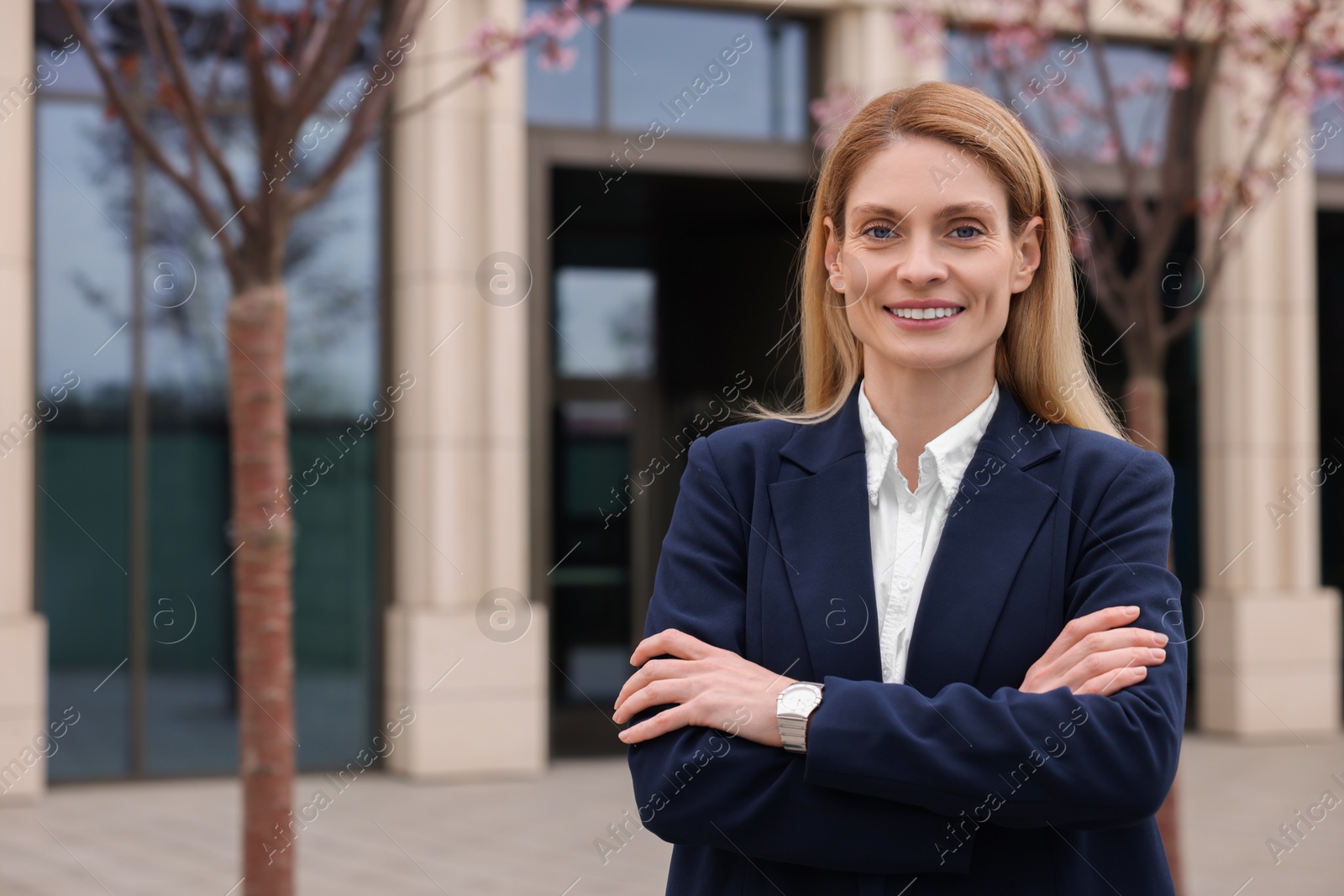 Photo of Happy real estate agent outdoors. Space for text