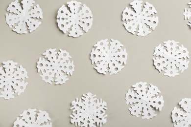 Many paper snowflakes on light grey background, flat lay