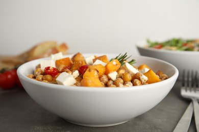 Delicious fresh chickpea salad on grey table