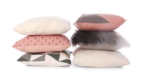 Stacks of different colorful pillows on white background