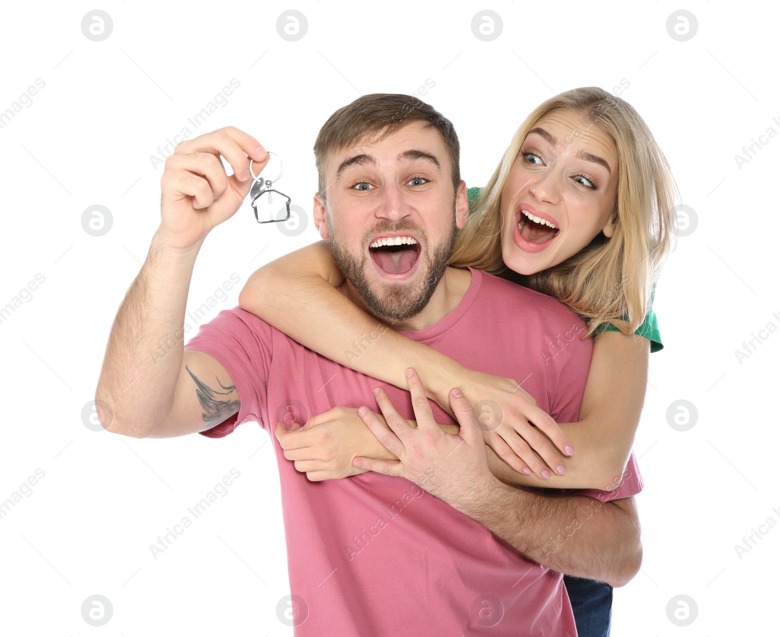 Photo of Emotional young couple with house key on white background