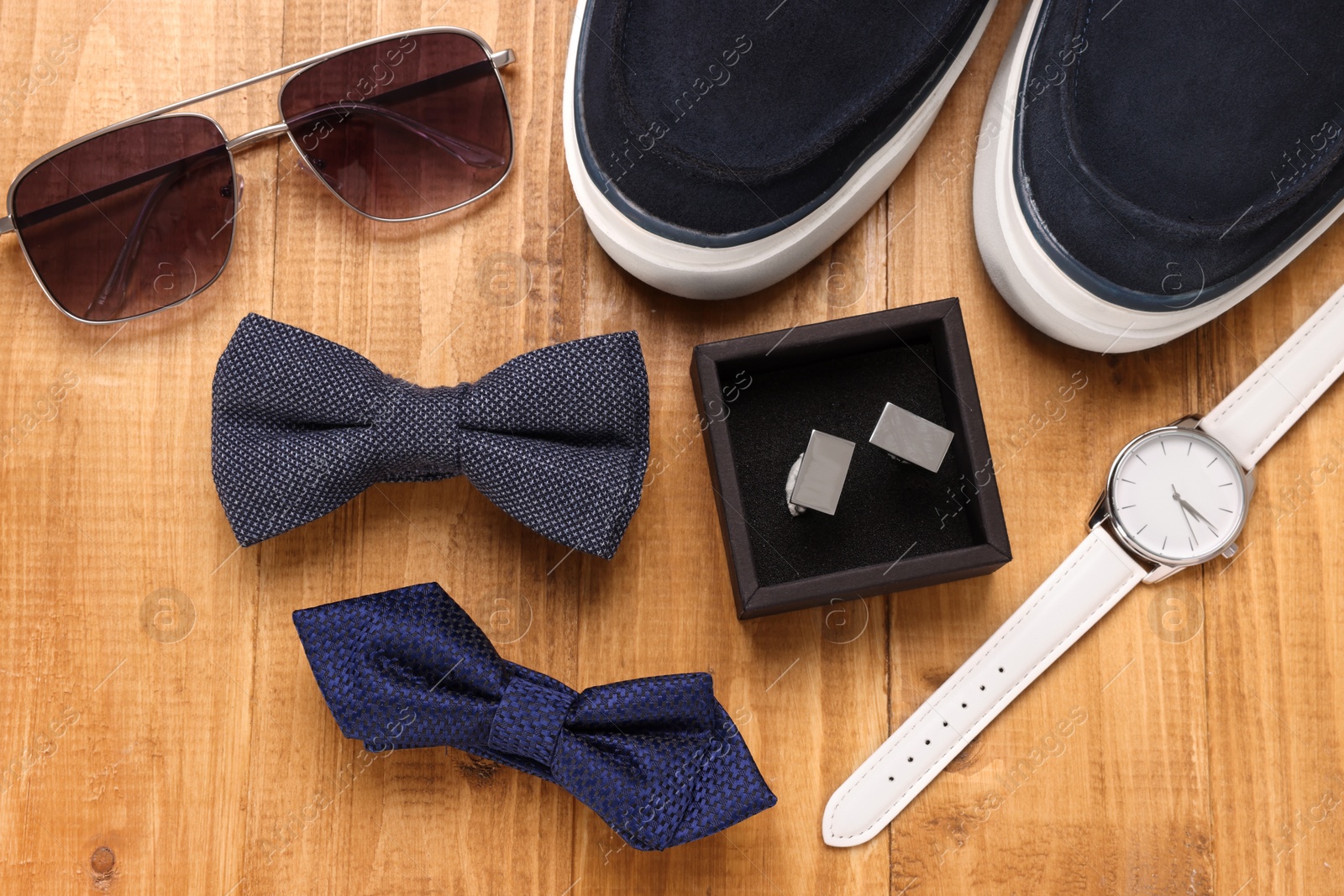 Photo of Flat lay composition with stylish color bow ties on wooden background