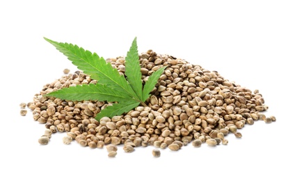 Photo of Pile of hemp seeds and leaf on white background