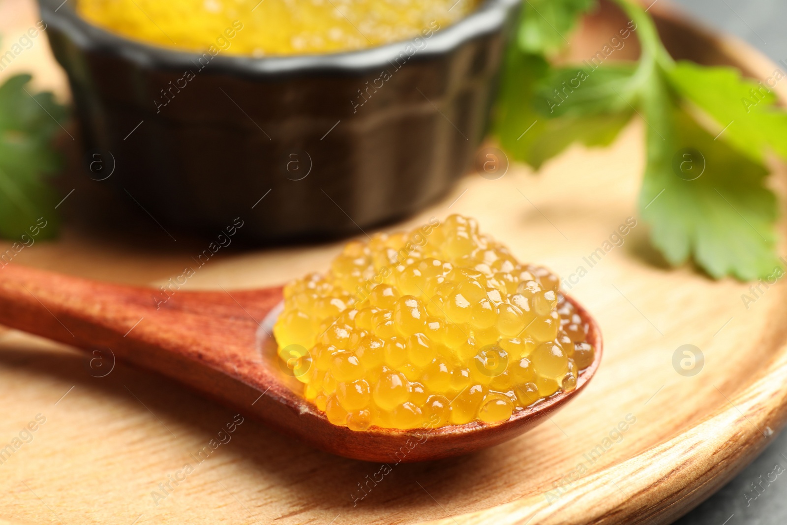 Photo of Fresh pike caviar and parsley on table, closeup