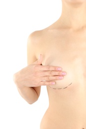 Photo of Young woman with marks on breast for cosmetic surgery operation against white background, closeup