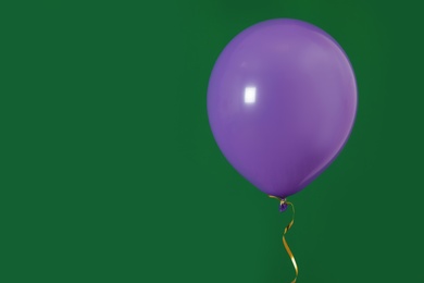 Bright balloon on color background, space for text. Celebration time