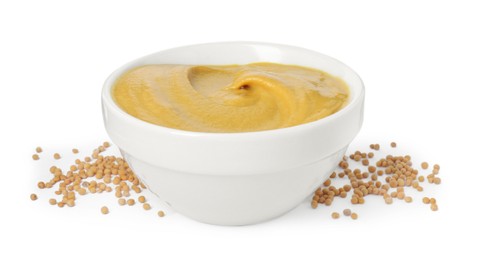 Fresh tasty mustard sauce in bowl and dry seeds isolated on white