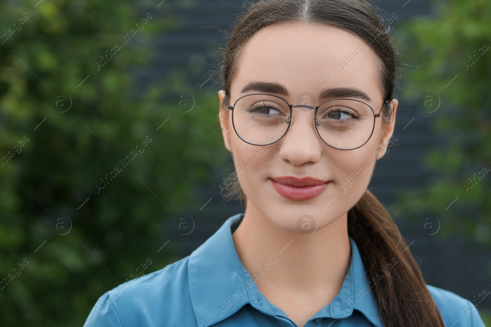 Photo of Portrait of beautiful woman in glasses on blurred background. Attractive lady posing for camera. Space for text