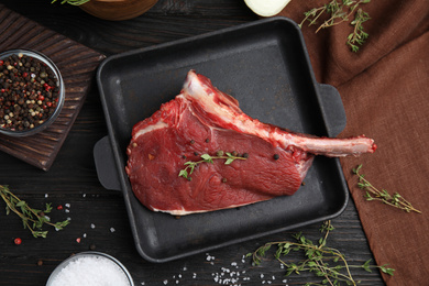 Photo of Flat lay composition with fresh beef cut on wooden table