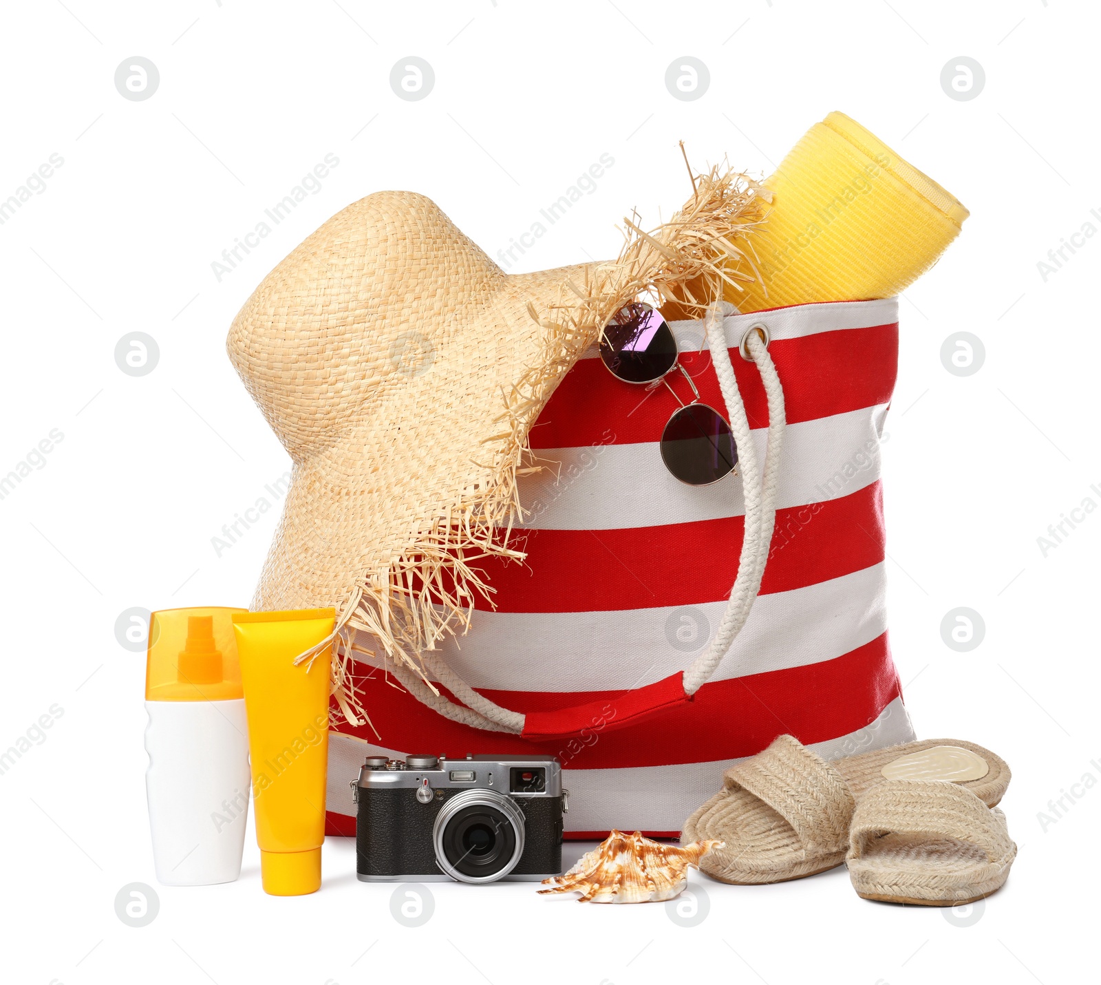 Photo of Stylish bag with beach accessories and camera isolated on white