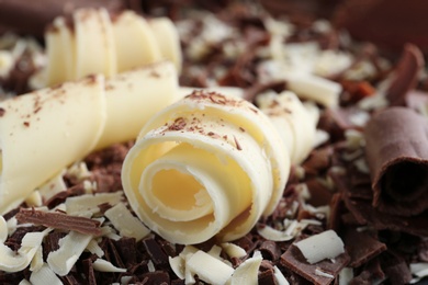 Yummy chocolate curls for decor as background, closeup