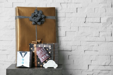 Photo of Gift boxes and toy car on table. Father's day celebration