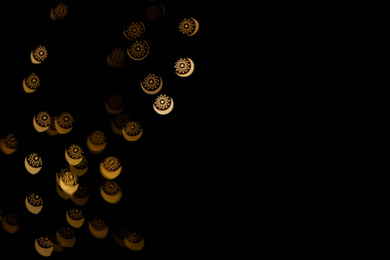 Photo of Blurred view of beautiful lights on black background. Bokeh effect