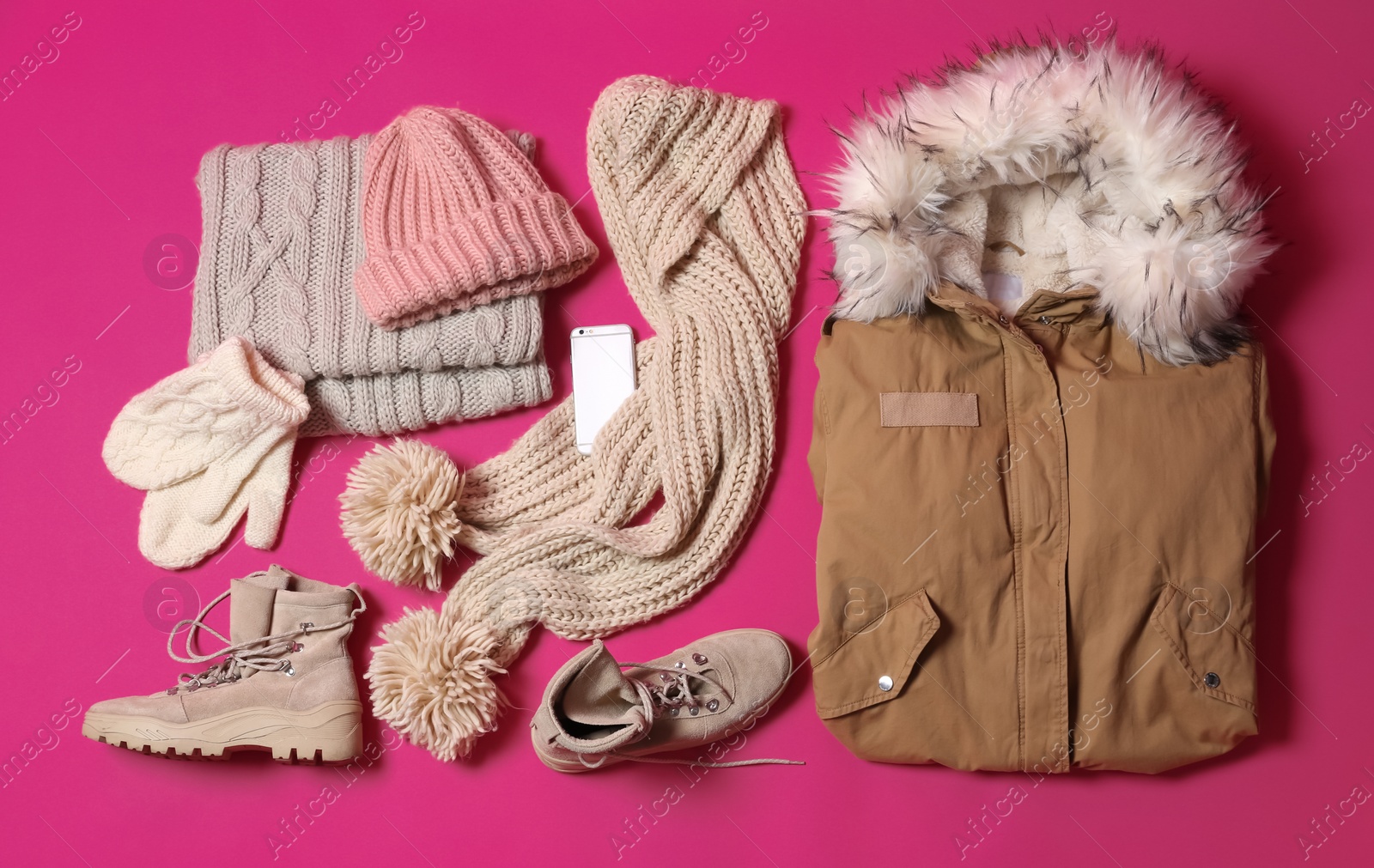 Photo of Flat lay composition with warm clothes for winter vacation on color background