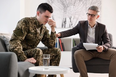 Professional psychotherapist working with military man in office