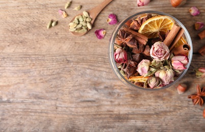 Photo of Aroma potpourri with different spices on wooden table, flat lay. Space for text