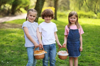 Easter celebration. Cute little children with wicker baskets outdoors