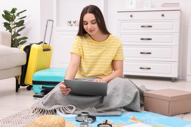 Photo of Travel blogger using laptop for planning trip at home