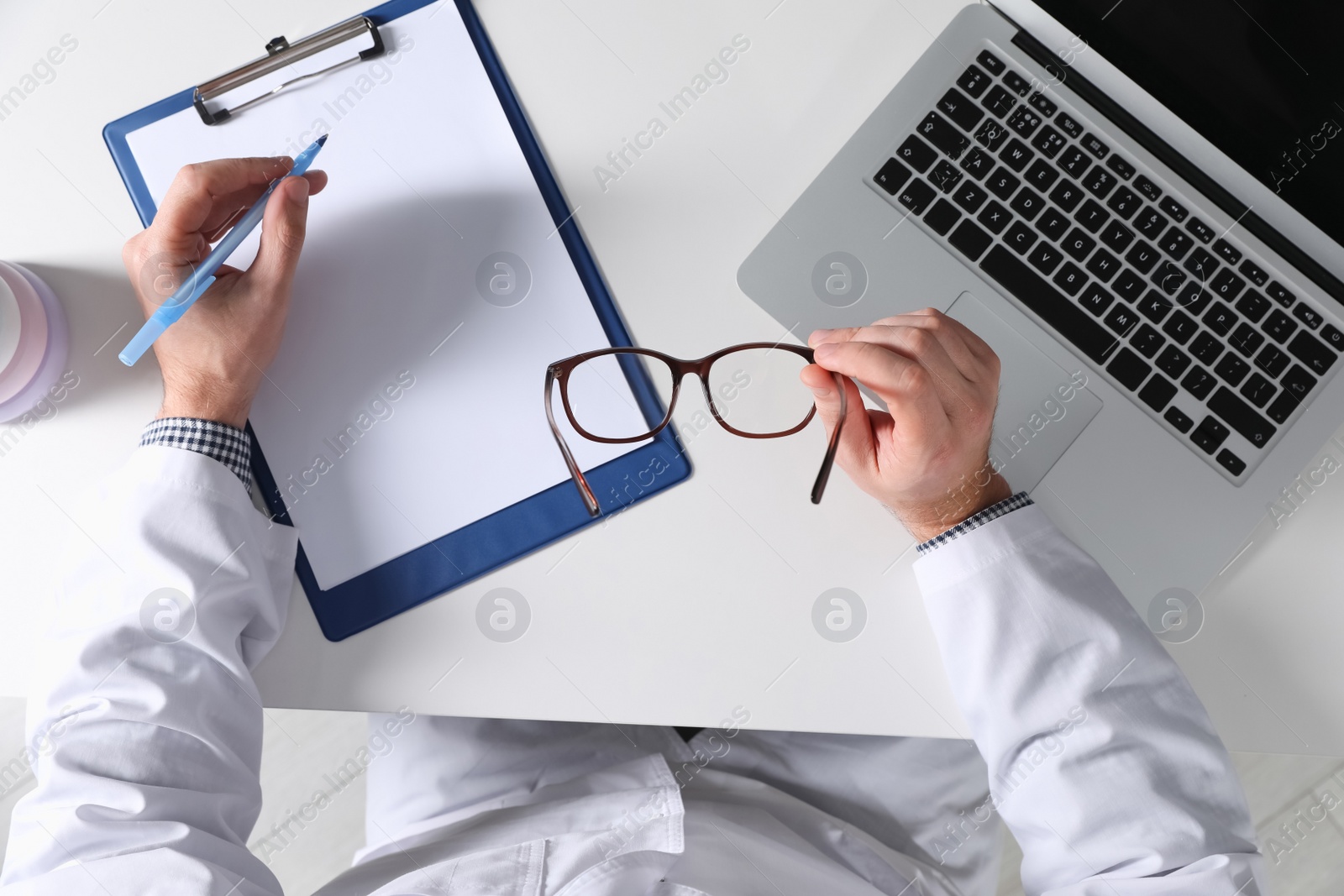 Photo of Pediatrician working at table in clinic, top view