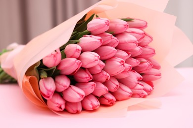 Bouquet of beautiful tulips on pink background, closeup